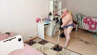 Mother-in-law vacuums the room naked
