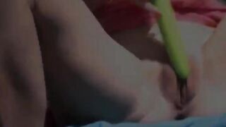 Two babes playing with dildos outside