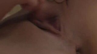 Busty teenager fingering sleek pussy