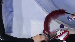 Two dominas play with a slaves dong