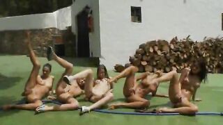 Five naked glamours getting wet outside