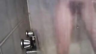 Petite skinny babe fingers and rubs pussy in the shower