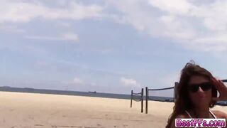 Girls playing with the boys on the beach together with their friends
