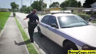 Two busty police officers in outdoor action with black dude
