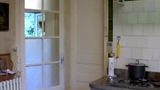 Brunette cougar with big tits gives head in kitchen